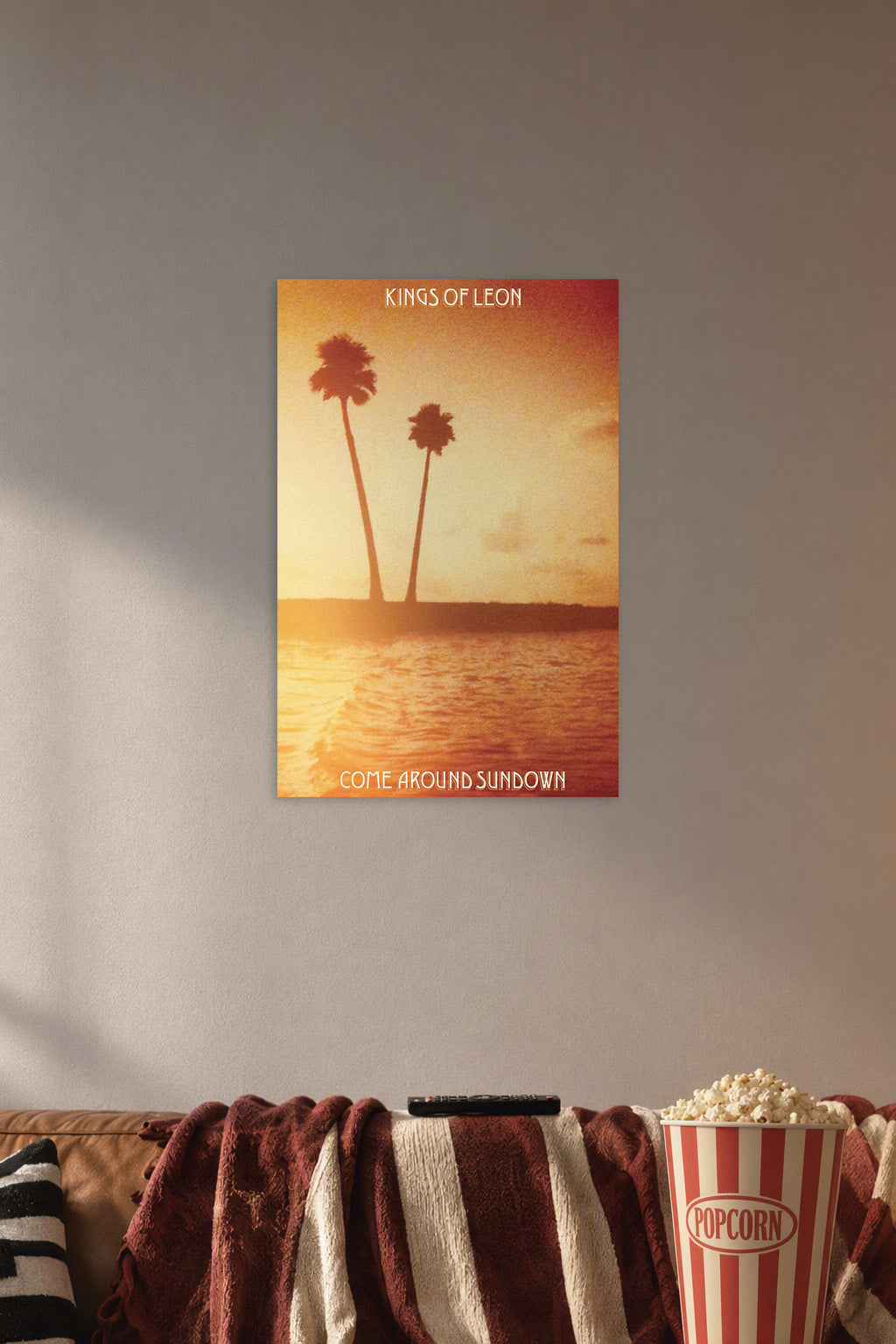 Kings of Leon Come Around Sundown Album Cover in a cozy movie room above a brown sofa with popcorn.