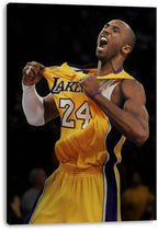 Kobe Bryant canvas wall art print features the athlete roaring and gripping his yellow Lakers number 24 jersey, displayed with wrapped edges.
