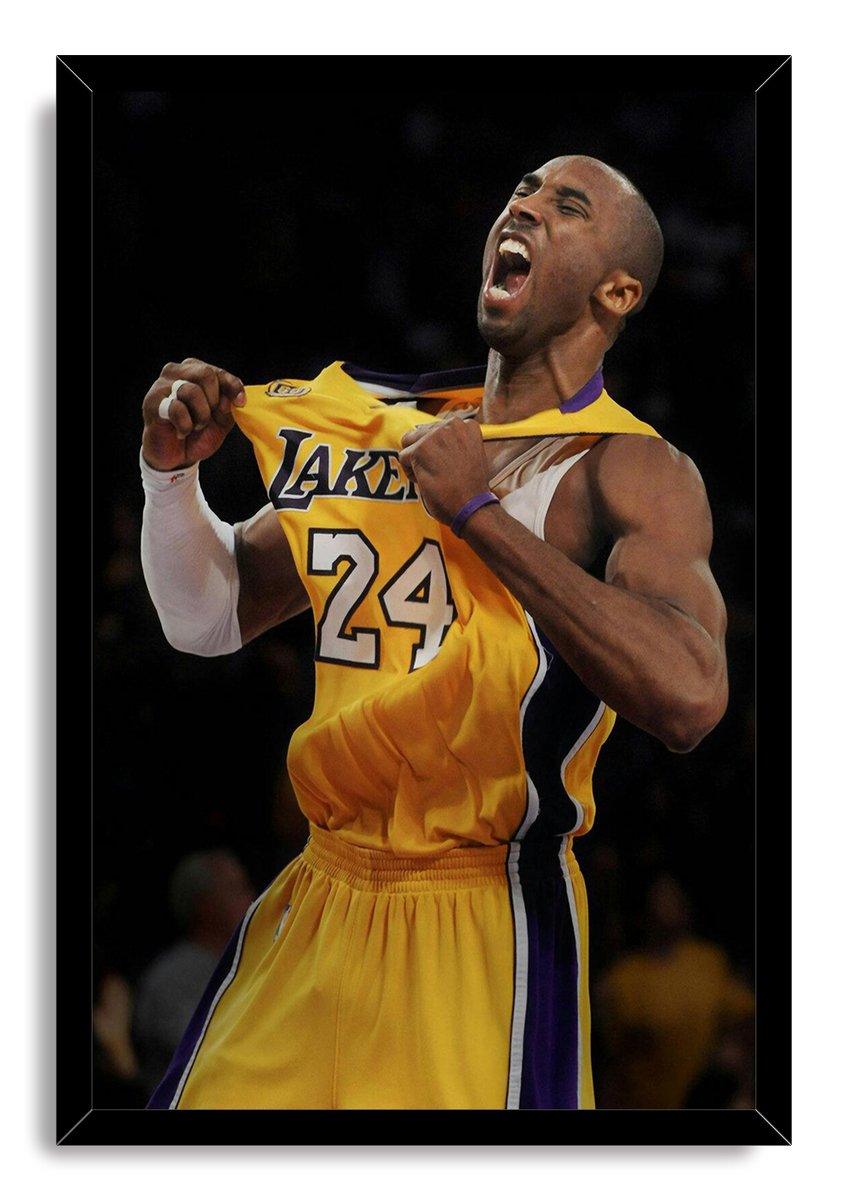 Kobe Bryant framed wall art print portrays the player yelling as he pulls his yellow Lakers number 24 jersey, set in a black frame.
