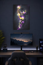 Kobe Bryant in a gaming desk setup above a monitor.