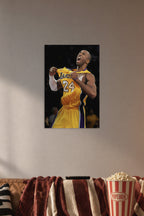 Kobe Bryant in a cozy movie room above a brown sofa with popcorn.