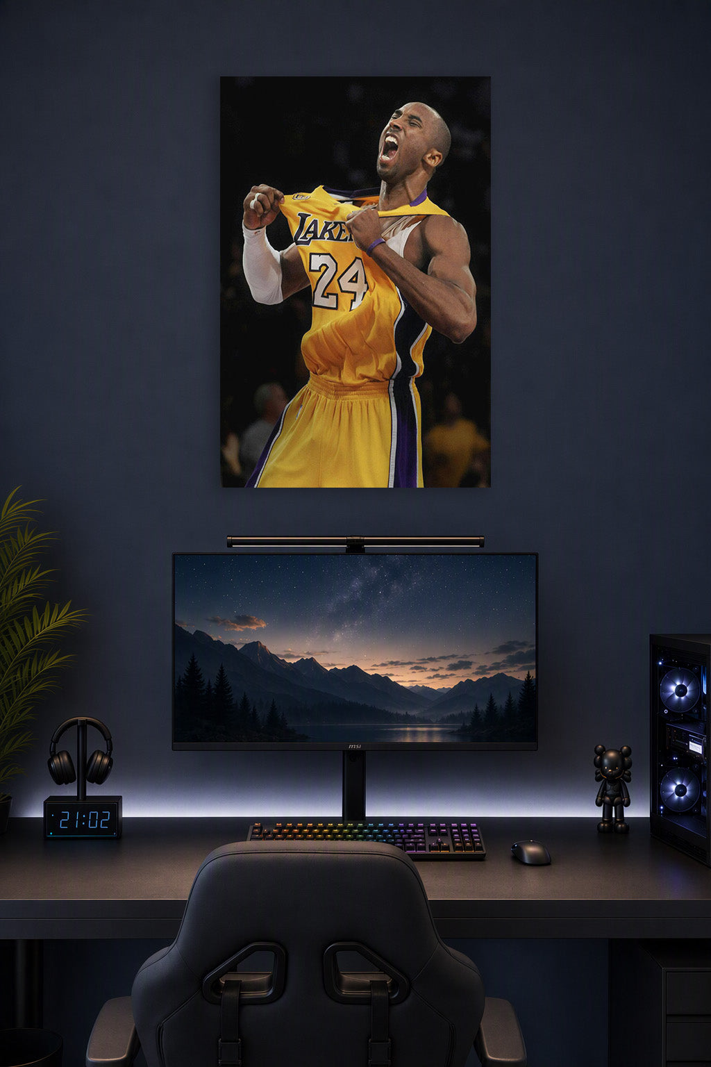 Kobe Bryant in a gaming desk setup above a monitor.