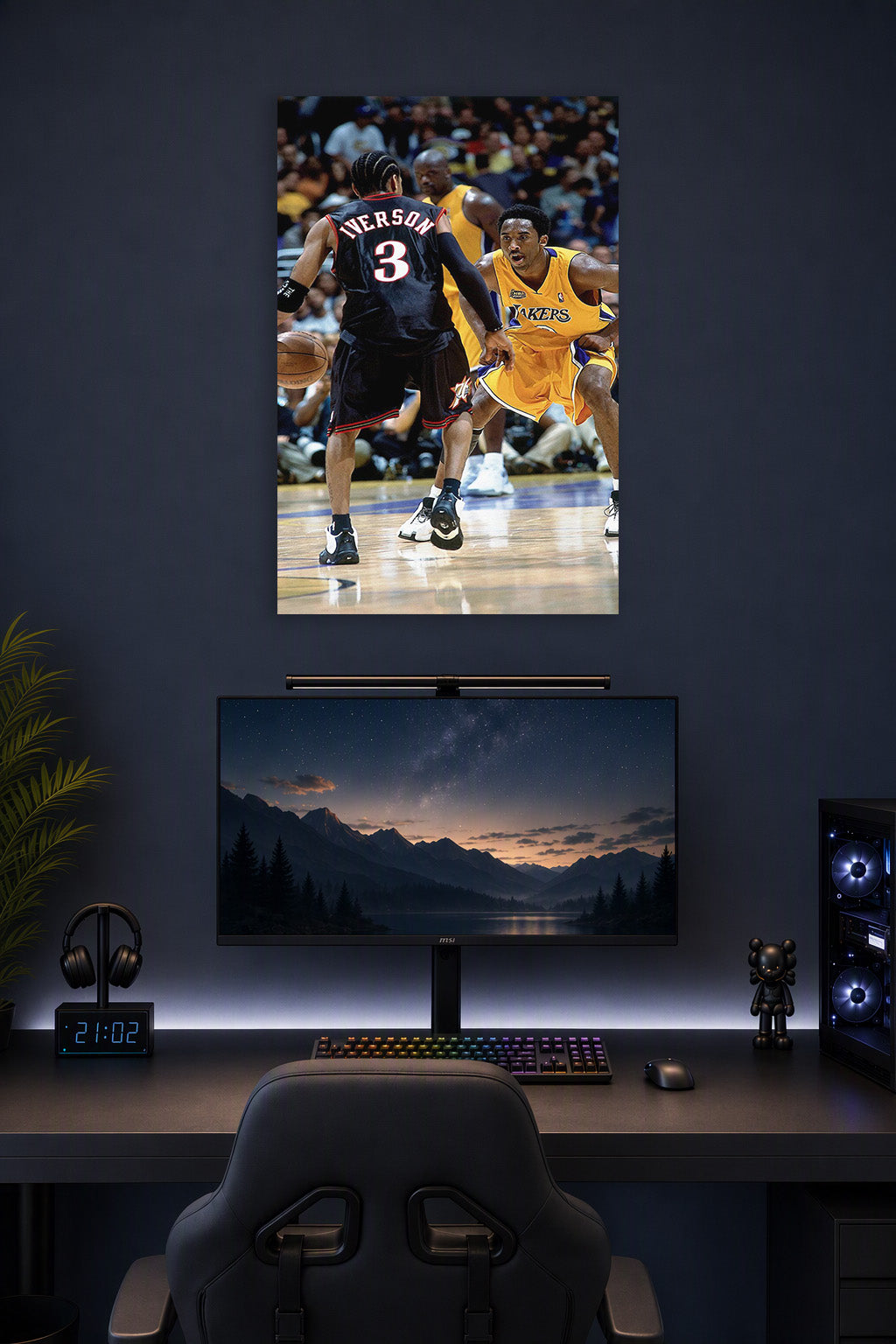 Kobe Bryant and Allen Iverson in a gaming desk setup above a monitor.