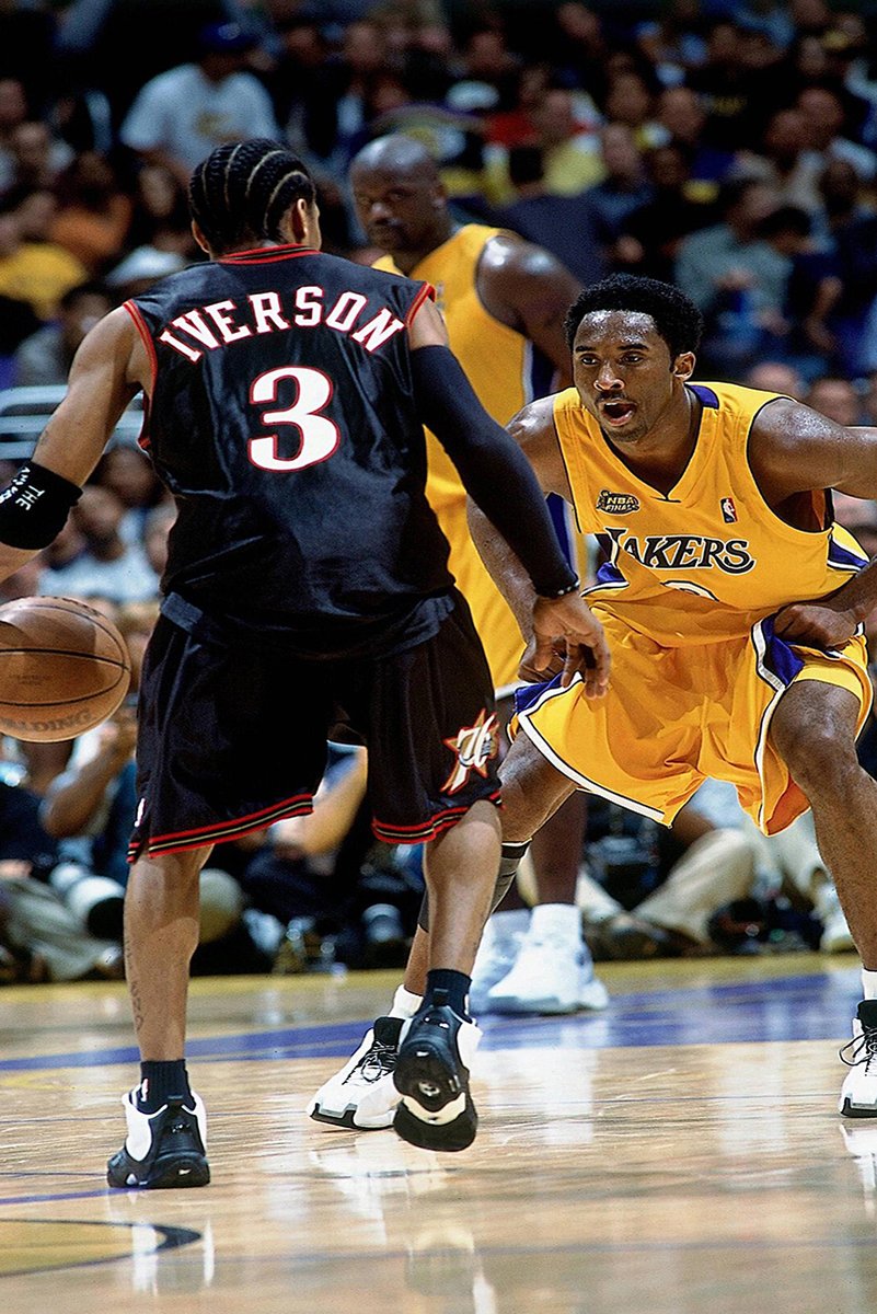 Kobe Bryant and Allen Iverson basketball poster captures Iverson dribbling against Bryant in gold Lakers uniform, with Shaquille O'Neal behind.