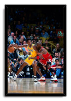 Kobe Bryant and Michael Jordan framed wall art print depicts Bryant handling the basketball in a yellow Lakers jersey against Jordan in a red Bulls uniform.