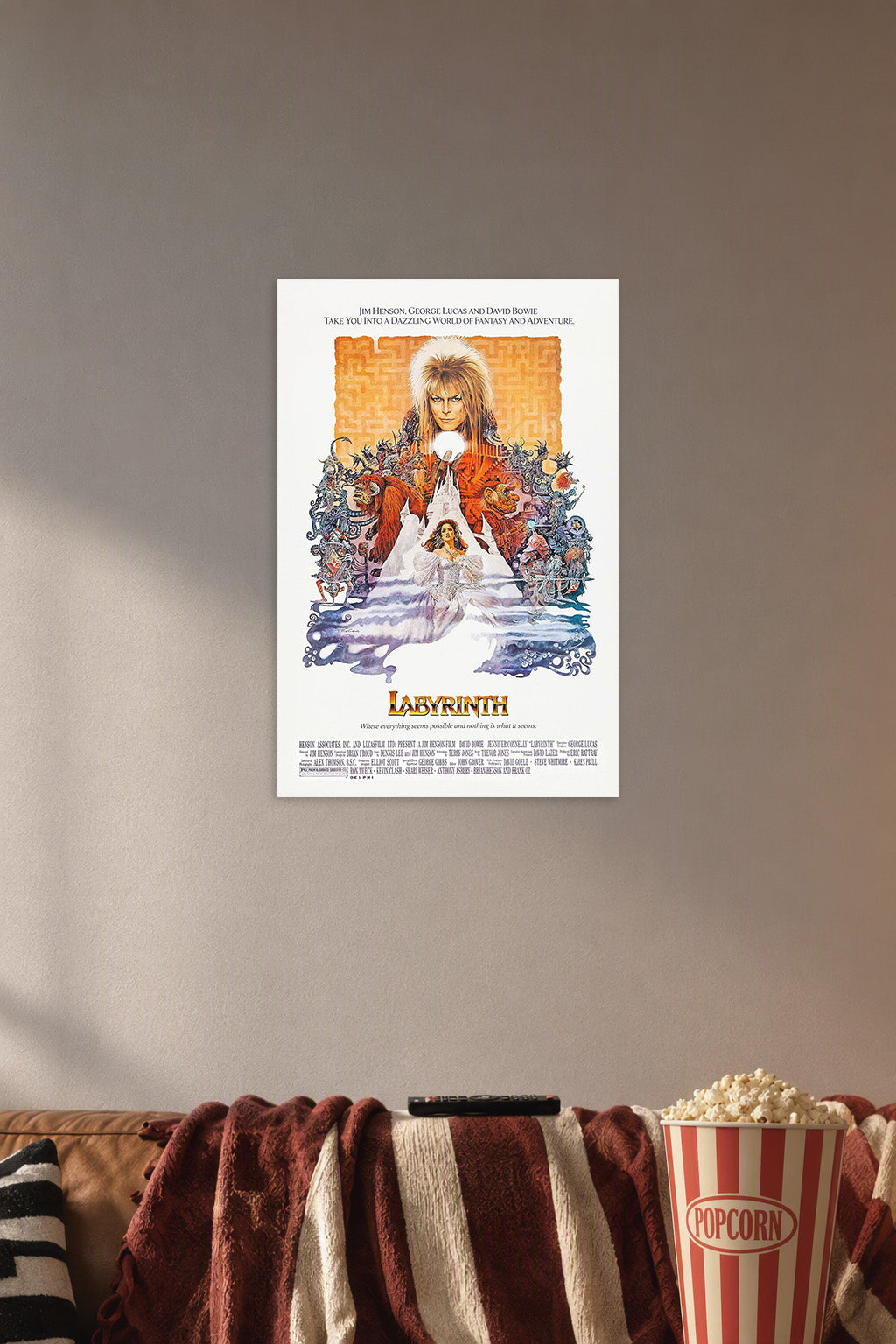 Labyrinth Movie Poster in a cozy movie room above a brown sofa with popcorn.