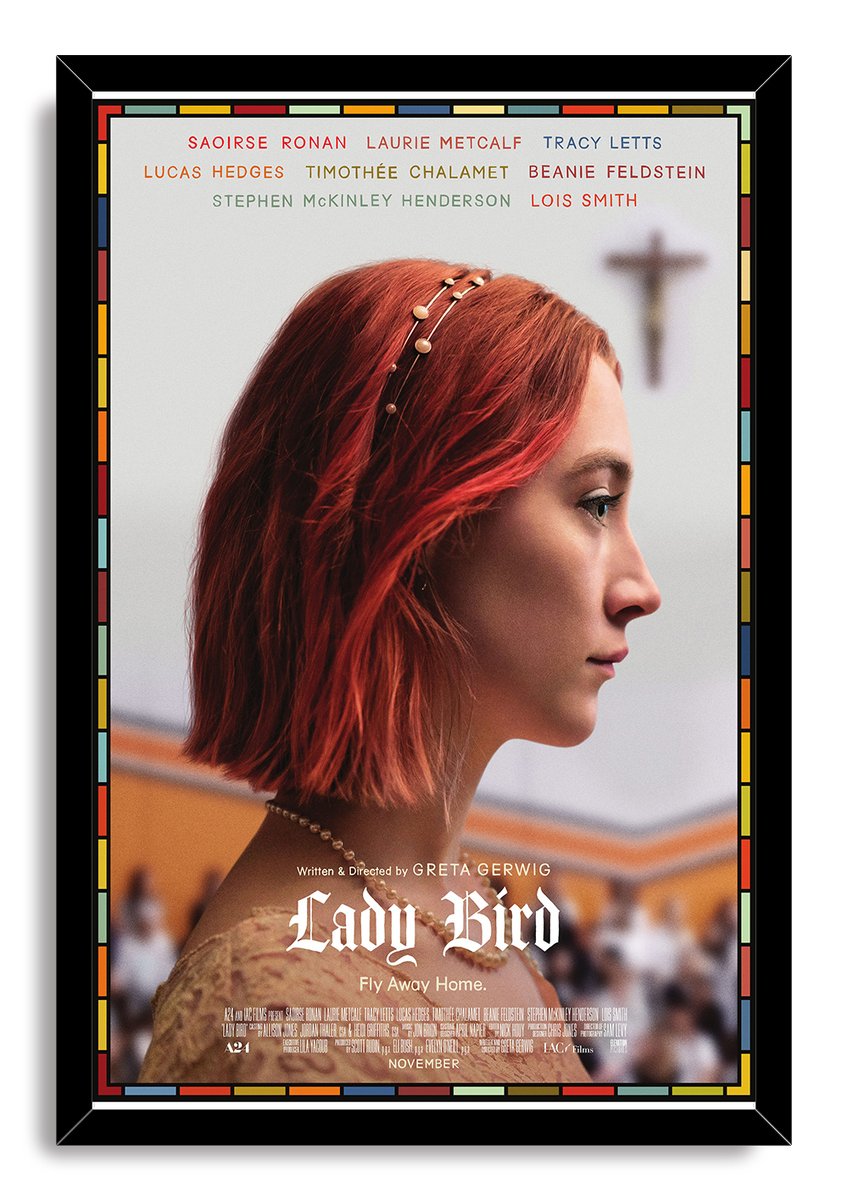 Lady Bird framed wall art print features a red-haired woman in profile against a blurred cross, set in a black frame.