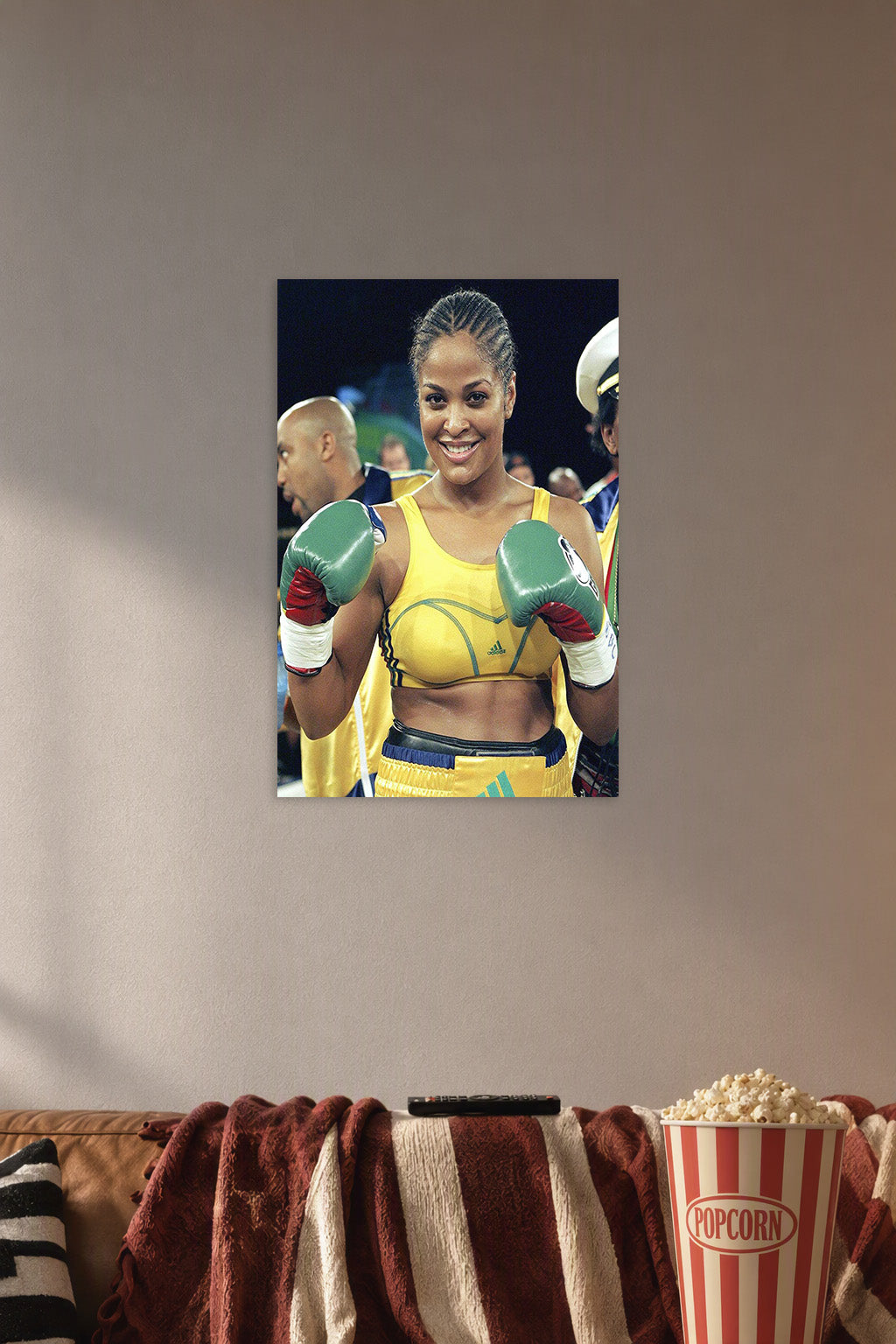 Laila Ali Boxer in a cozy movie room above a brown sofa with popcorn.