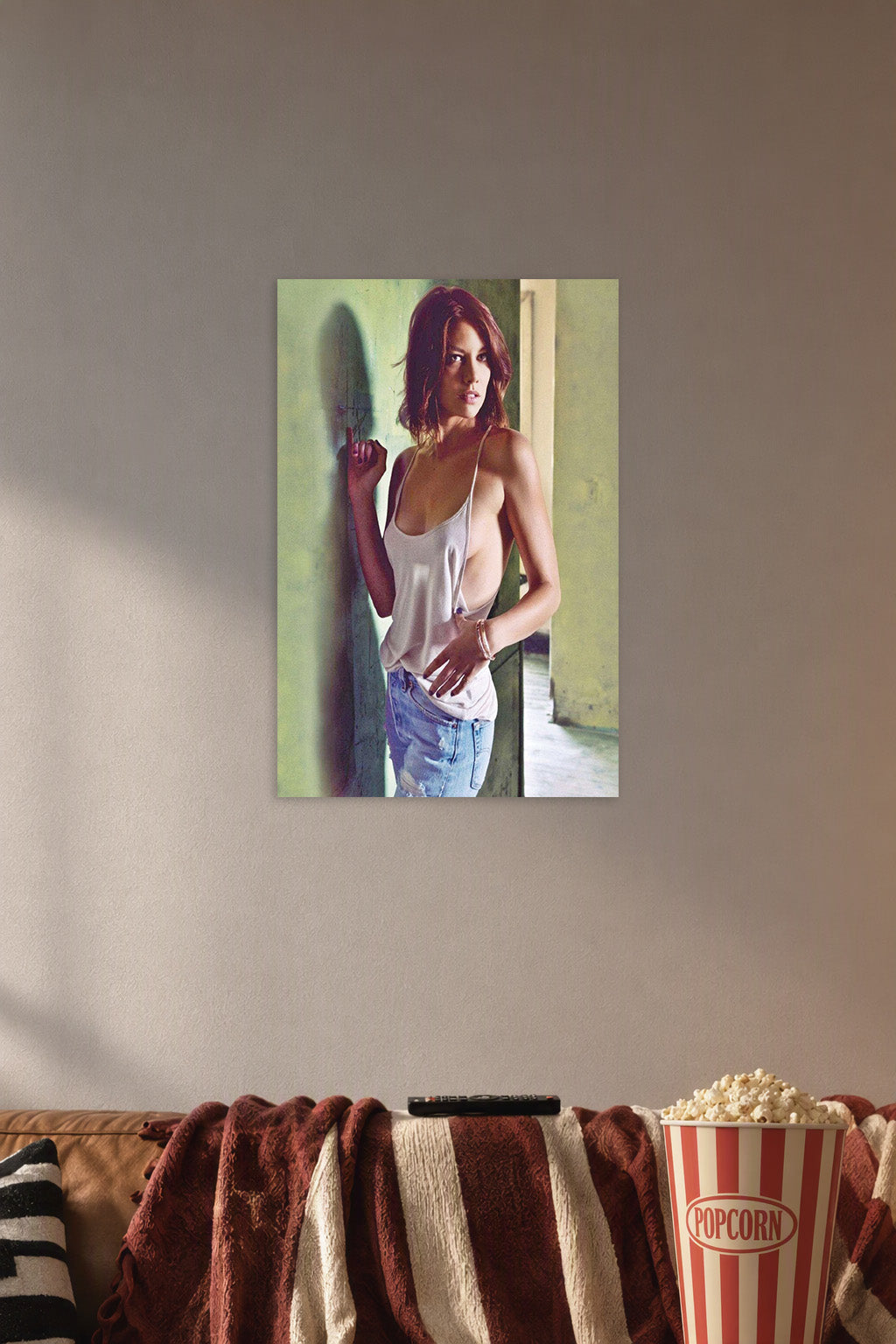 Lauren Cohan in a cozy movie room above a brown sofa with popcorn.