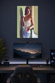 Lauren Cohan in a gaming desk setup above a monitor.
