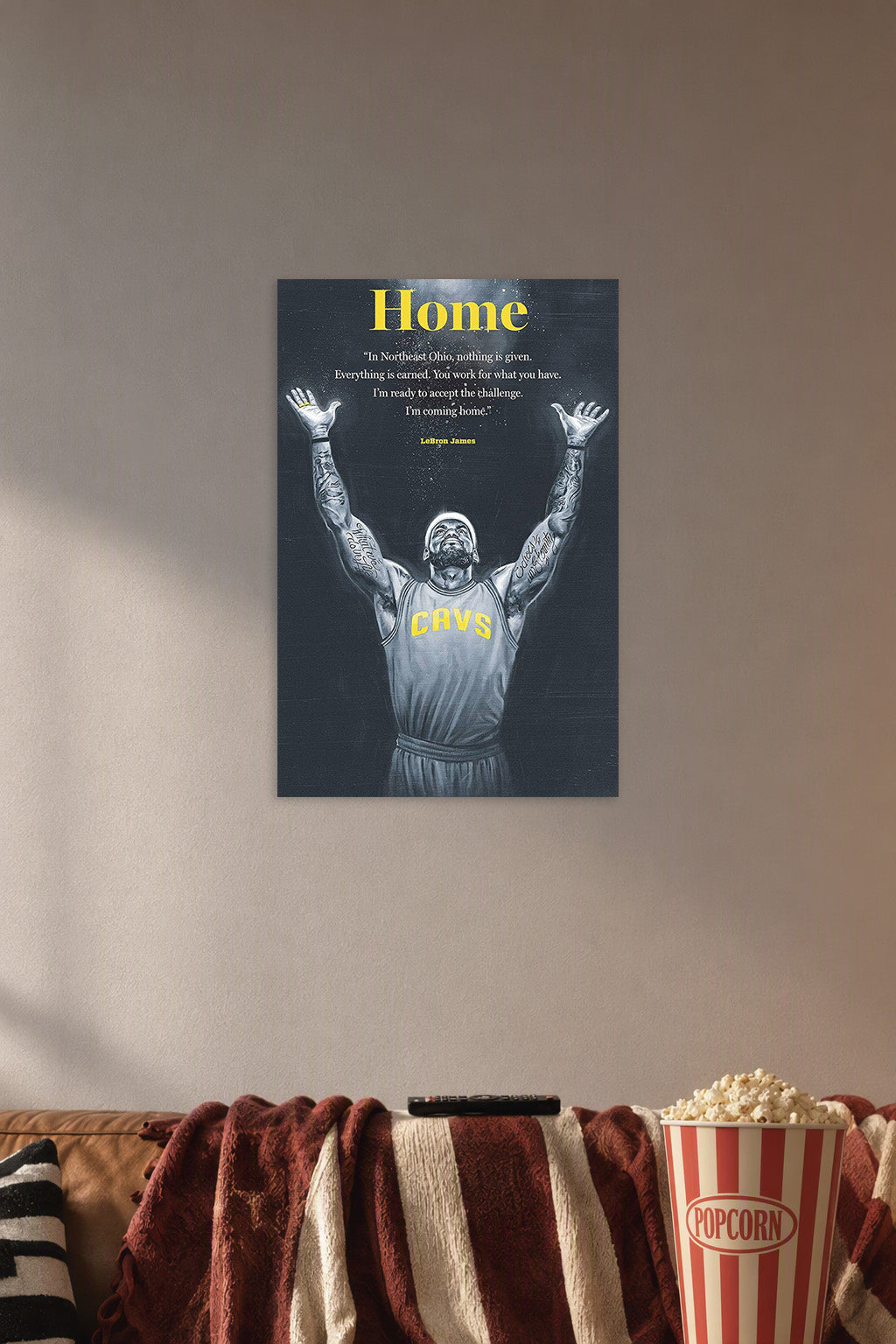 LeBron James in a cozy movie room above a brown sofa with popcorn.