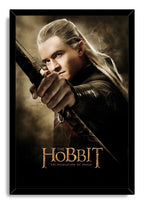 Legolas framed wall art print portrays the focused elf archer aiming his bow, bordered by a black frame and Hobbit title.