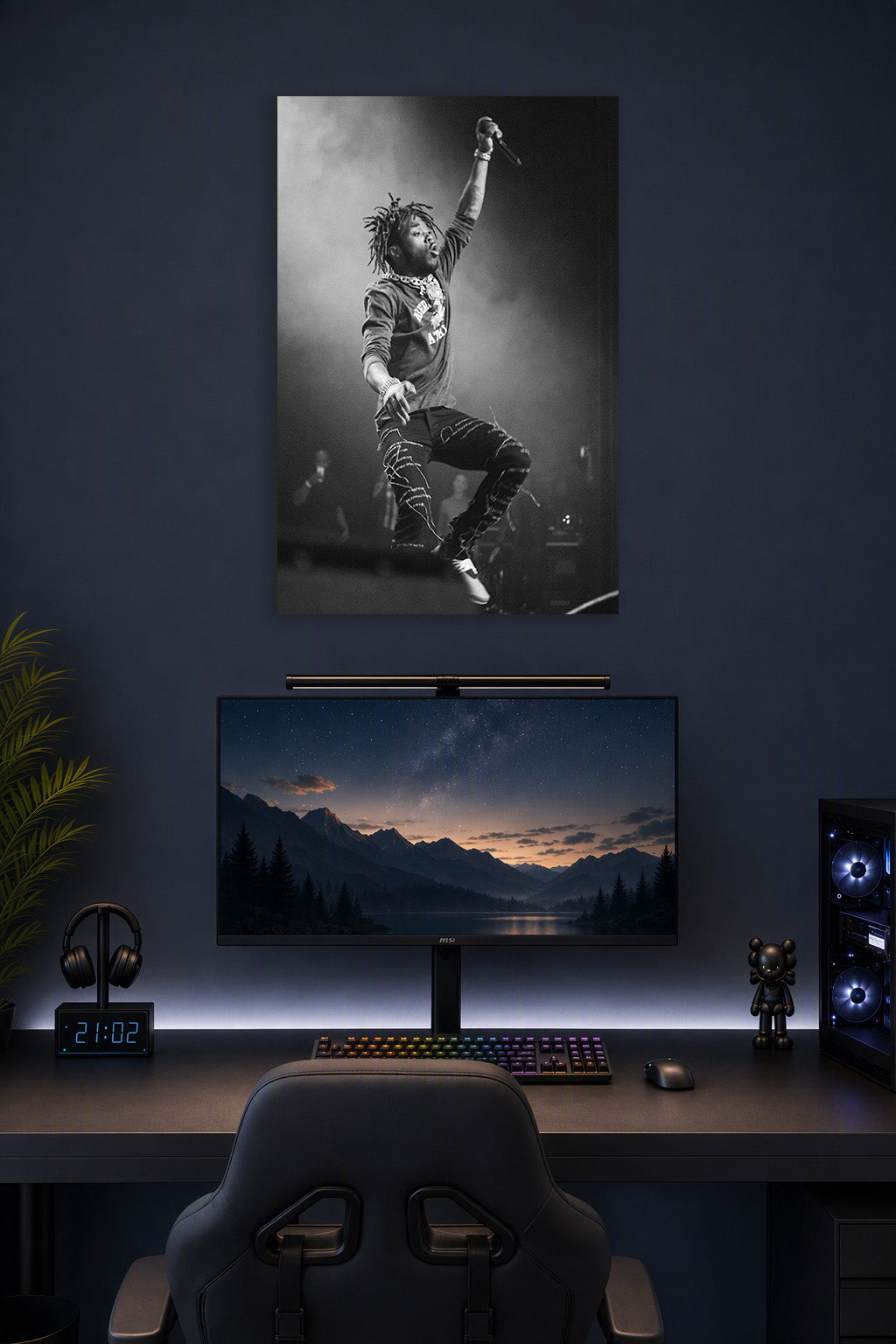 Lil Uzi Vert in a gaming desk setup above a monitor.