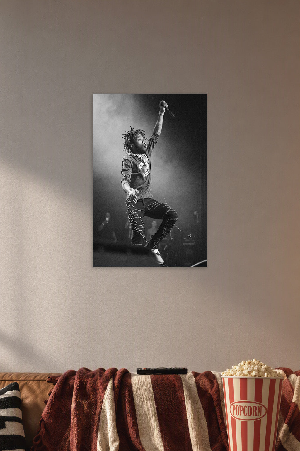 Lil Uzi Vert in a cozy movie room above a brown sofa with popcorn.