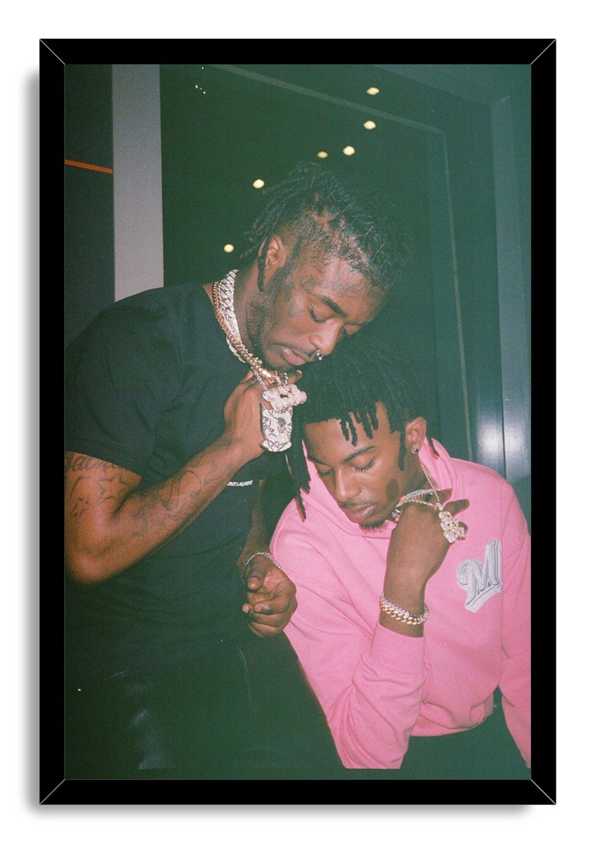 Lil Uzi Vert and Playboi Carti framed wall art print portrays the two artists looking downward against a dark background in a black frame.