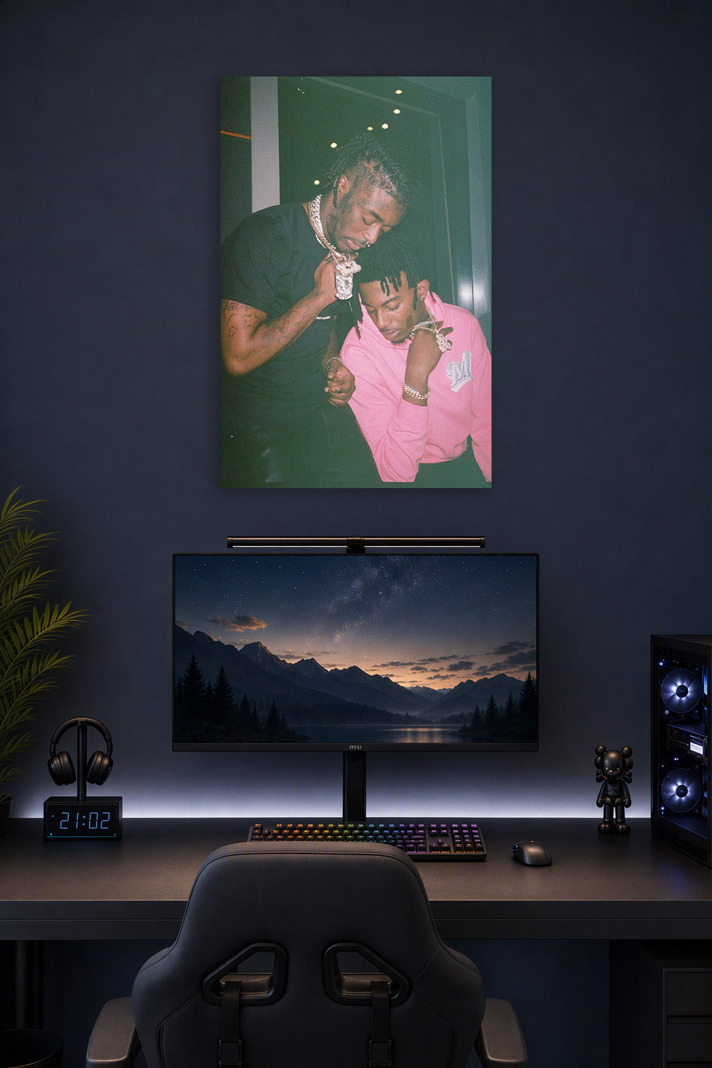 Lil Uzi Vert and Playboi Carti in a gaming desk setup above a monitor.
