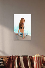 Long-Haired Woman by the Water in a cozy movie room above a brown sofa with popcorn.