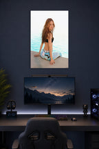 Long-Haired Woman by the Water in a gaming desk setup above a monitor.