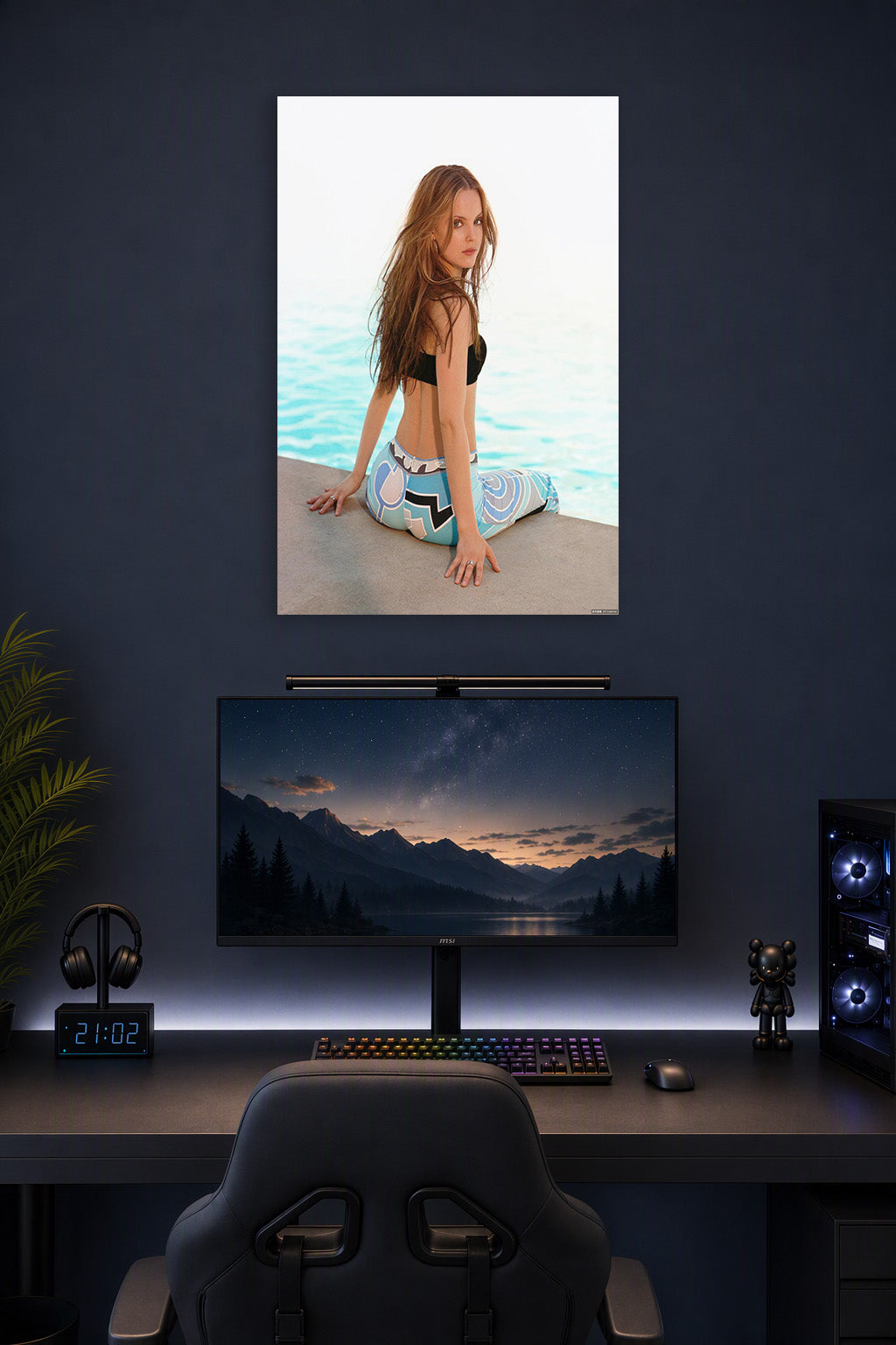 Long-Haired Woman by the Water in a gaming desk setup above a monitor.