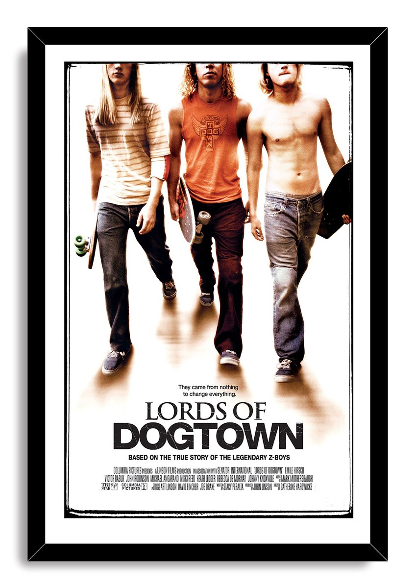 Lords of Dogtown framed wall art print presents three skateboard-carrying young men above bold title lettering in a black frame.