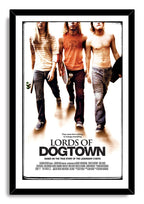 Lords of Dogtown framed wall art print presents three skateboard-carrying young men above bold title lettering in a black frame.