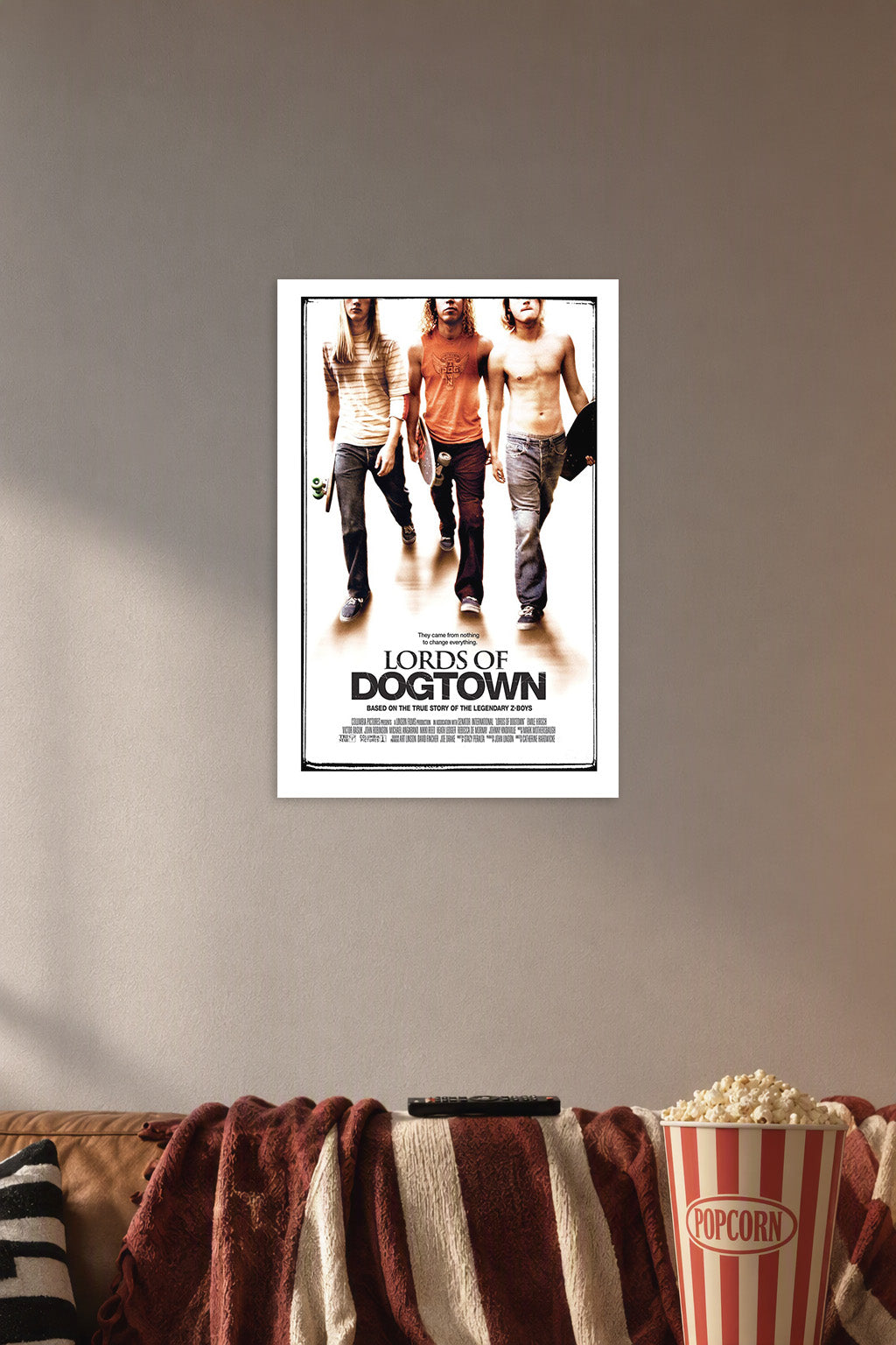Lords of Dogtown in a cozy movie room above a brown sofa with popcorn.