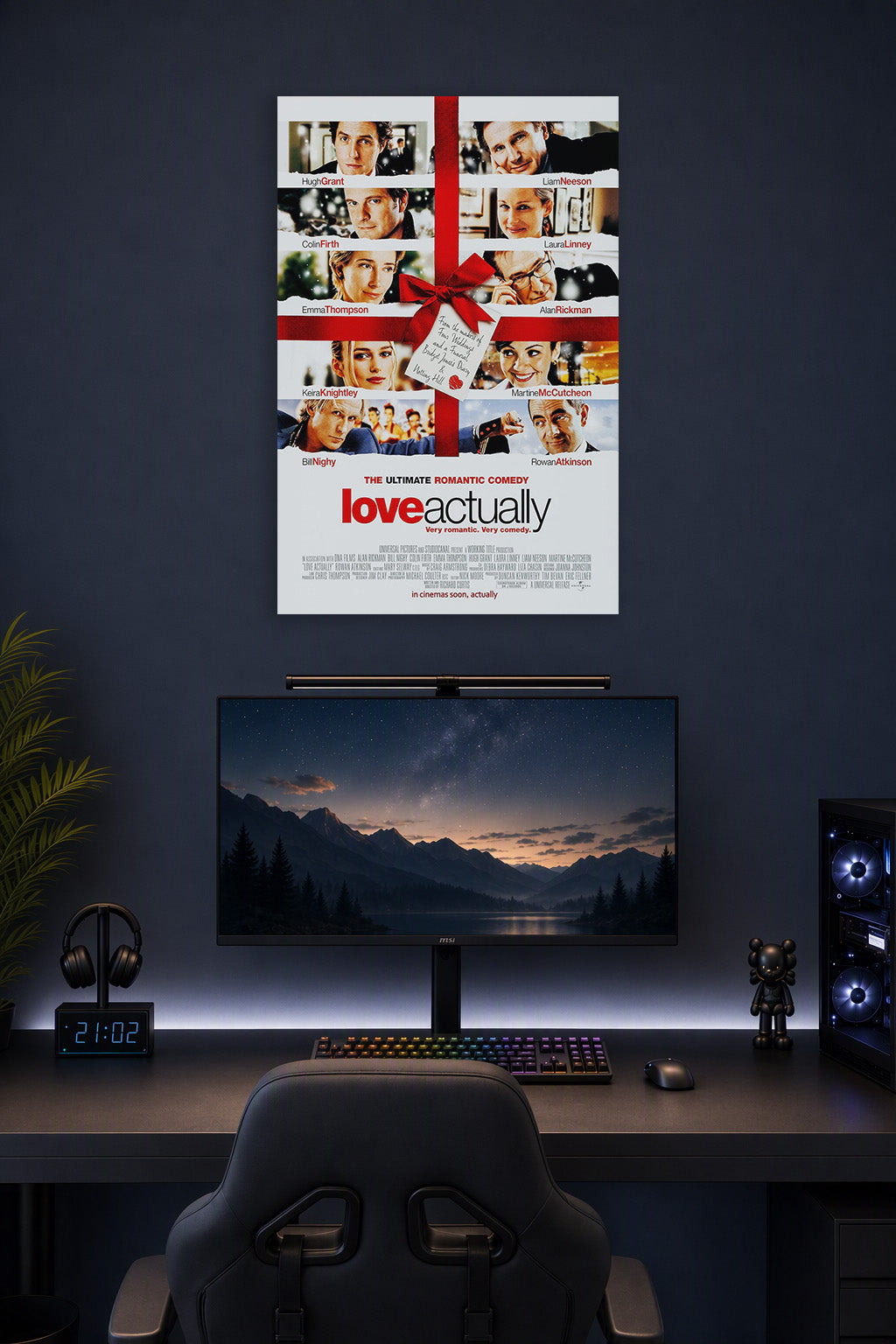 Love Actually Movie Poster in a gaming desk setup above a monitor.