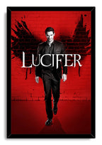 Lucifer Morningstar framed wall art print depicts a man in a dark suit before red bricks, black wing shapes, and large white Lucifer text.