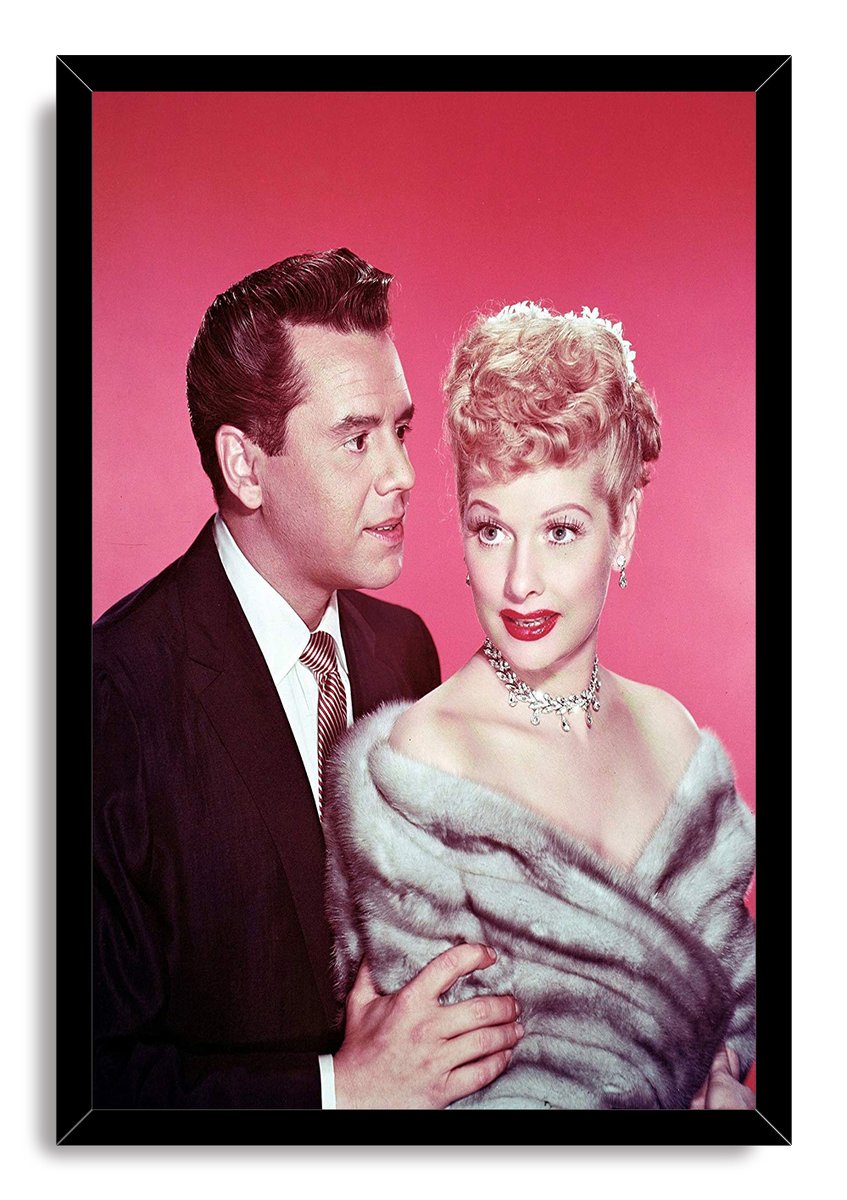 Lucille Ball and Desi Arnaz framed wall art print, with Ball in a fur stole and Arnaz beside her on a pink backdrop.