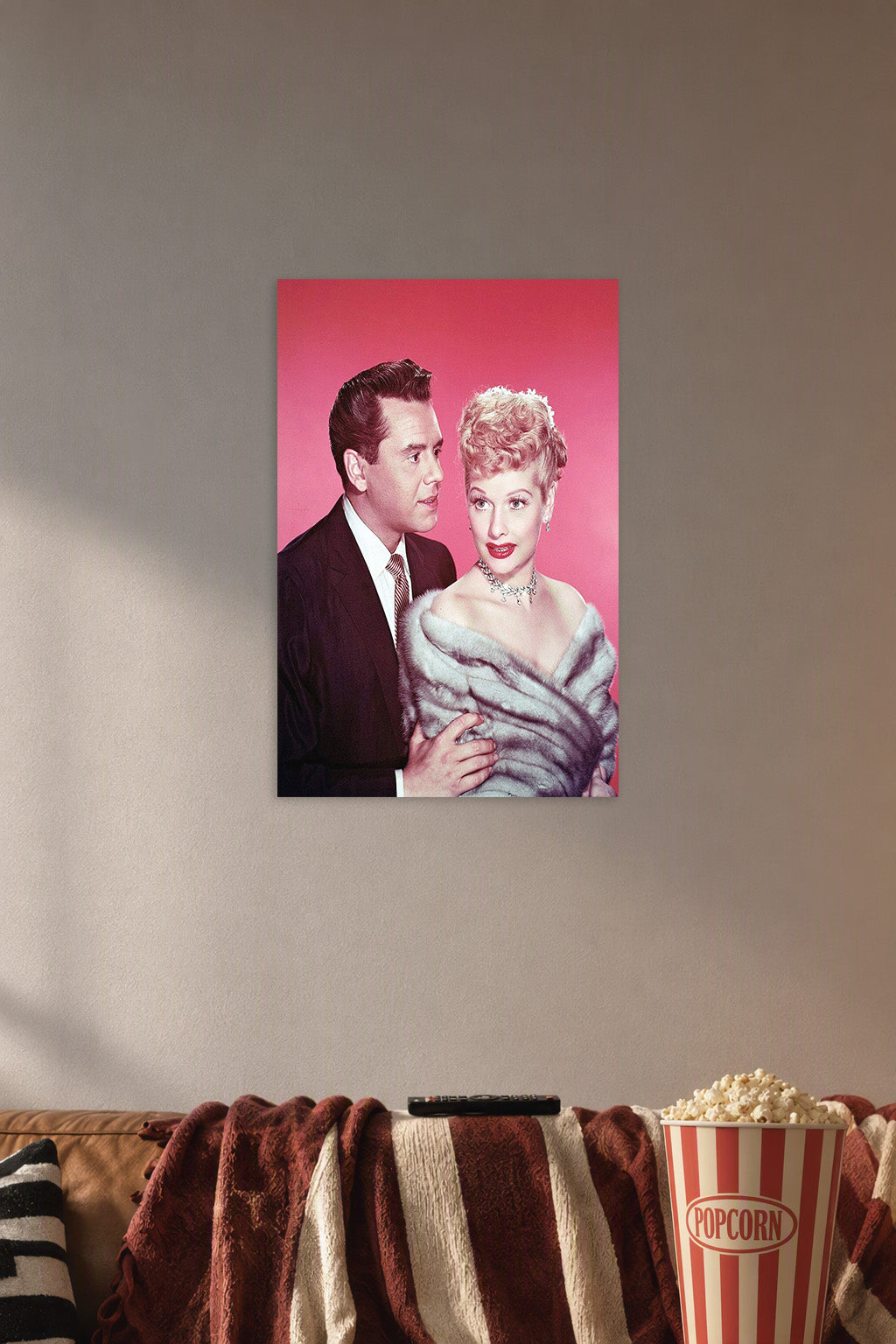 Lucille Ball Desi Arnaz in a cozy movie room above a brown sofa with popcorn.