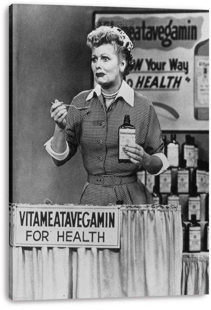 Lucille Ball Vitameatavegamin canvas wall art print, with Lucy holding a spoon and bottle at a promotional display.