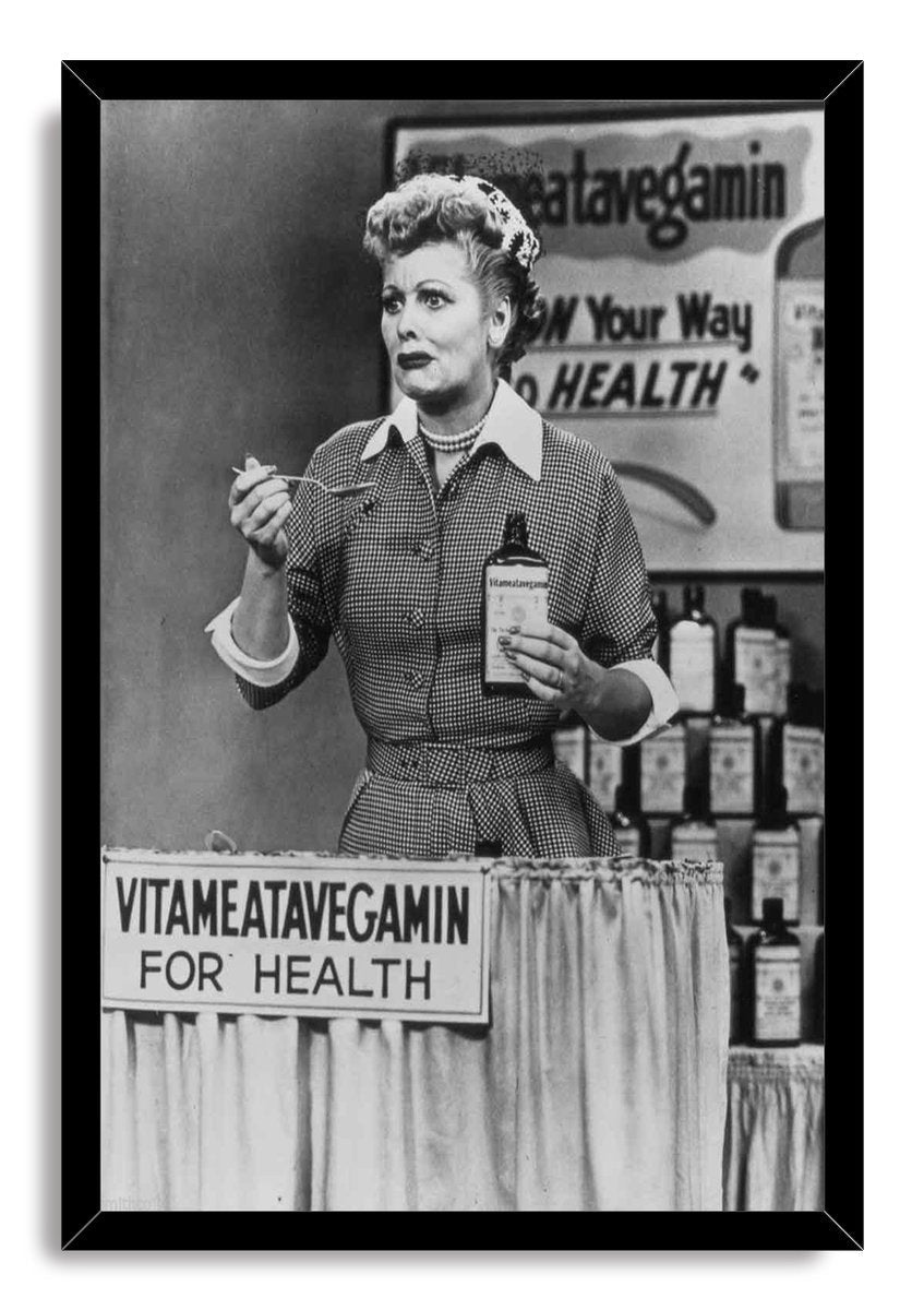 Lucille Ball Vitameatavegamin framed wall art print in black and white, featuring Lucy with a spoon, bottle, and health sign.