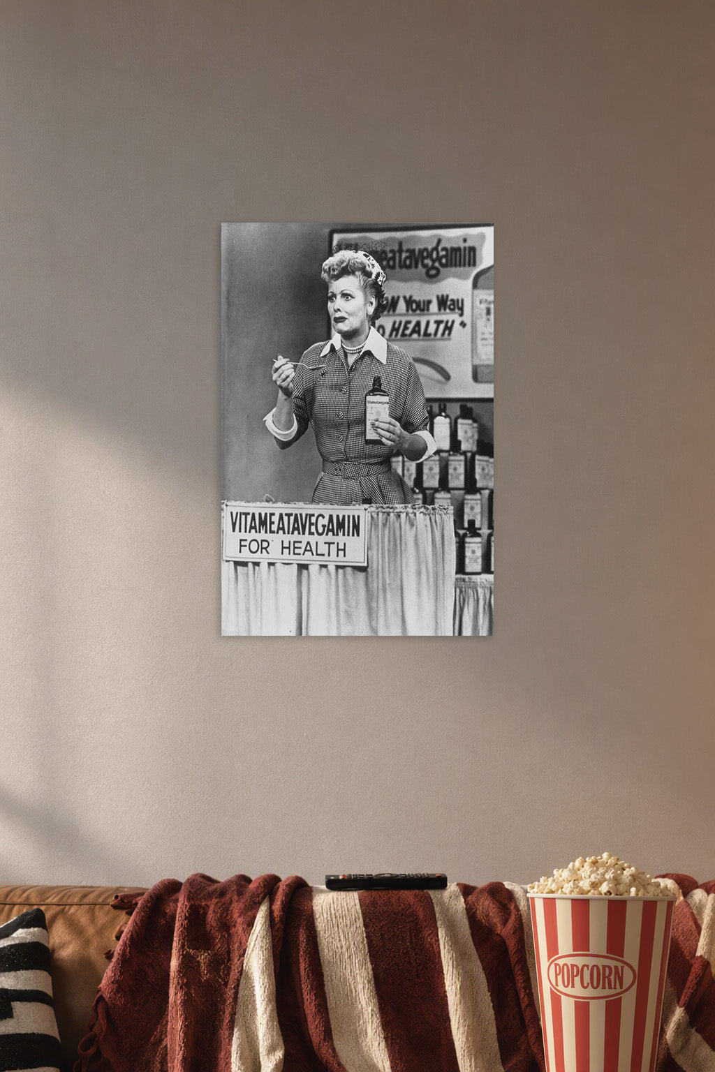 Lucille Ball I Love Lucy Vitameatavegamin in a cozy movie room above a brown sofa with popcorn.