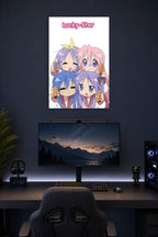 Lucky Star Anime Girls in a gaming desk setup above a monitor.