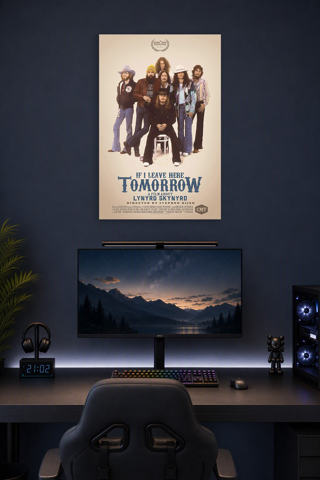 Lynyrd Skynyrd Band 'If I Leave Here Tomorrow' Movie Poster art poster print in a gaming desk setup above a monitor.