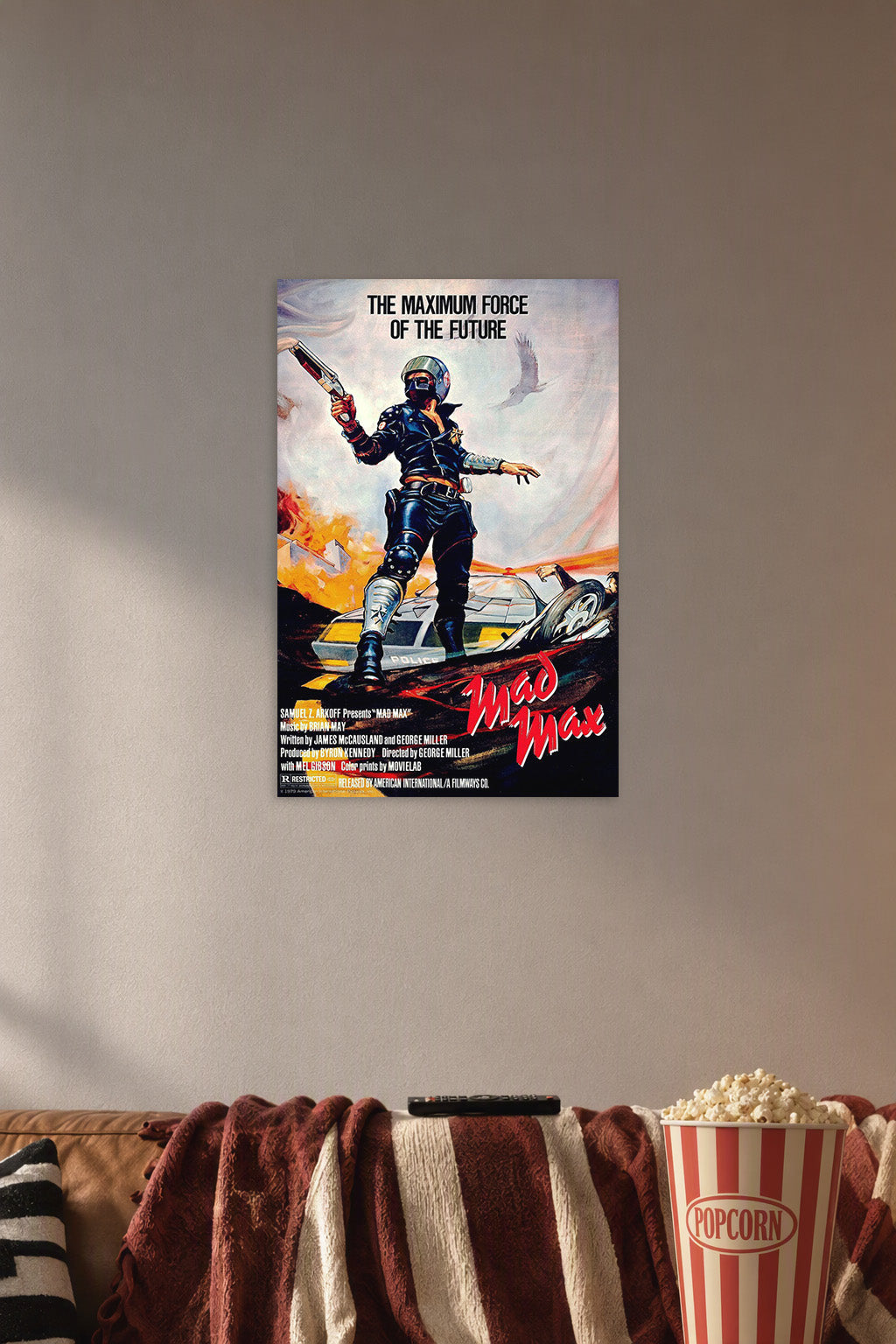Mad Max in a cozy movie room above a brown sofa with popcorn.