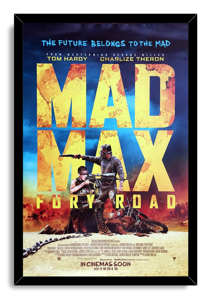 Mad Max: Fury Road framed wall art print with black border, bold yellow title, armed figures, motorcycle, and stormy blue sky.
