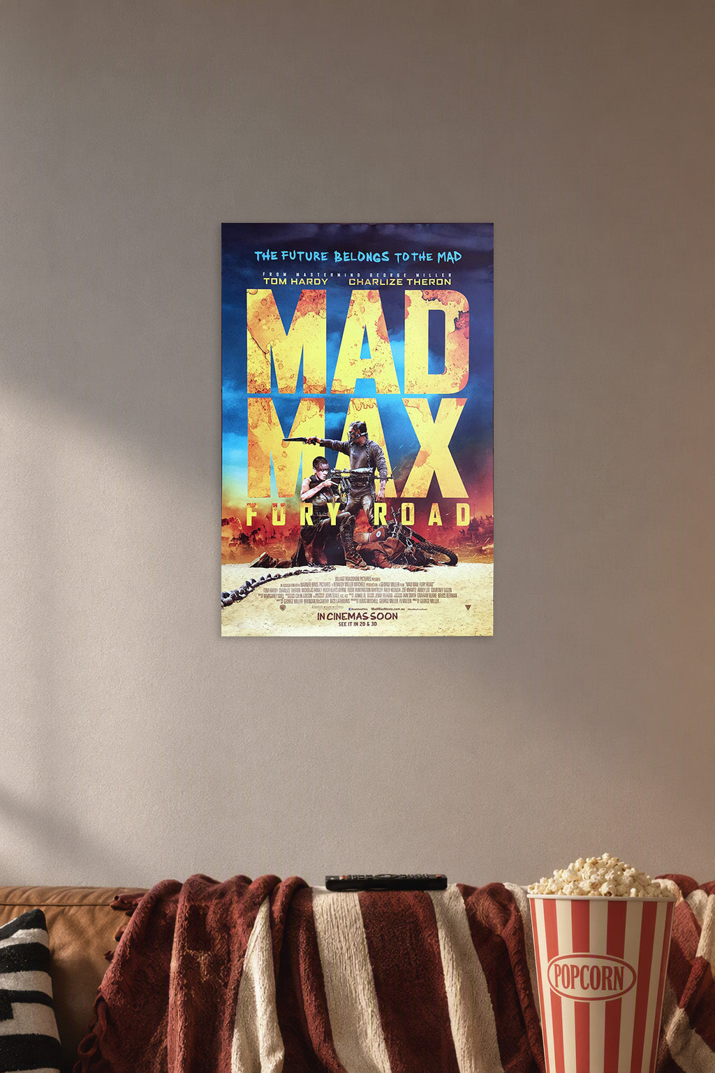 Mad Max: Fury Road in a cozy movie room above a brown sofa with popcorn.