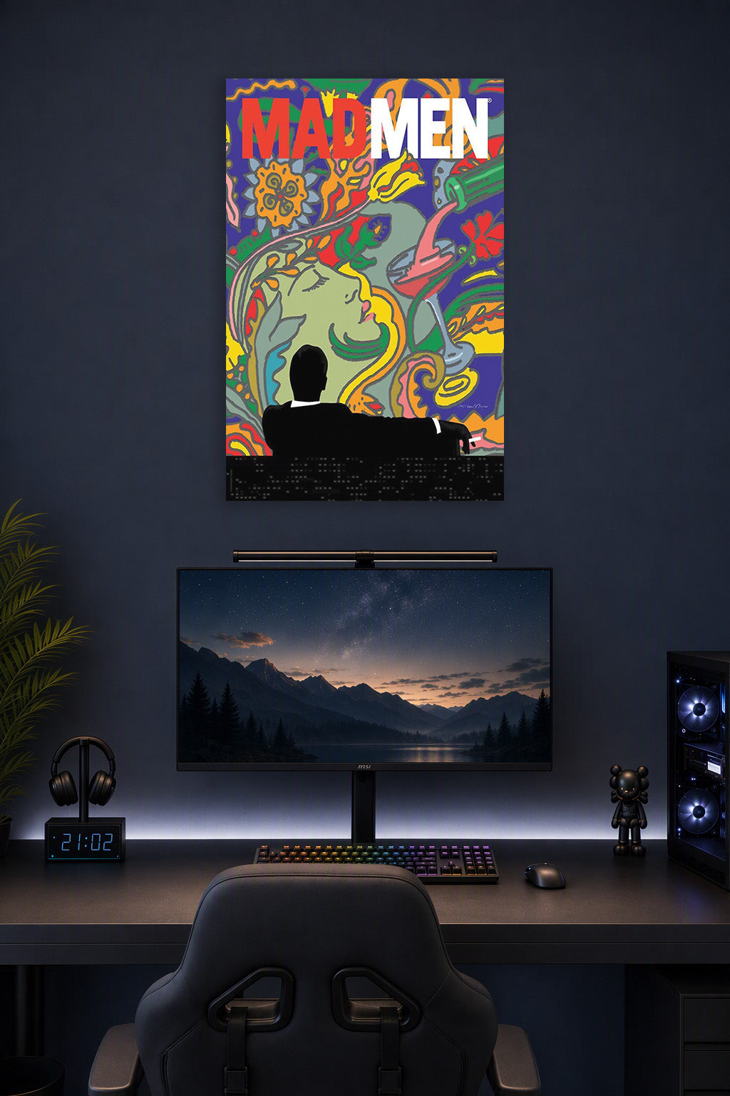 Mad Men in a gaming desk setup above a monitor.
