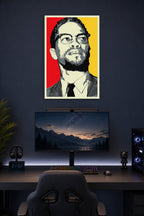 Malcolm X in a gaming desk setup above a monitor.