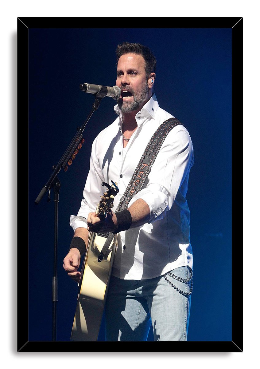 Male singer framed wall art print features a guitarist singing into a microphone, dressed in white against a dark blue concert backdrop.