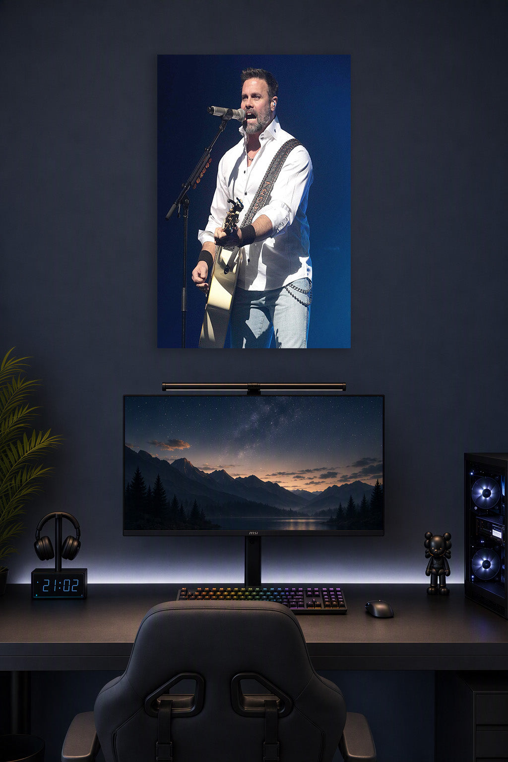 Male Singer Performing in a gaming desk setup above a monitor.