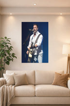 Male Singer Performing in a bright living room above a beige sofa.