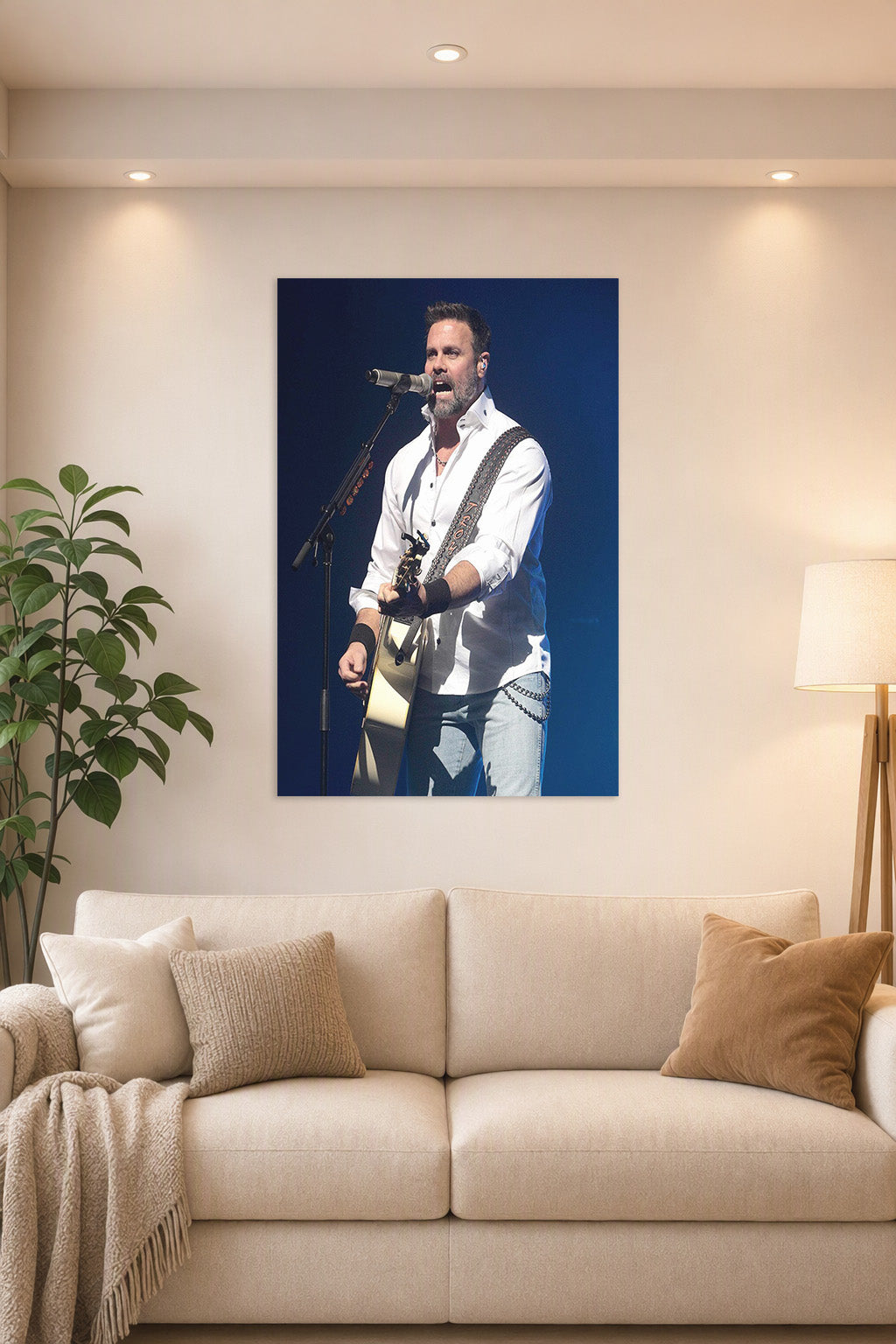 Male Singer Performing in a bright living room above a beige sofa.
