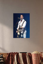Male Singer Performing in a cozy movie room above a brown sofa with popcorn.