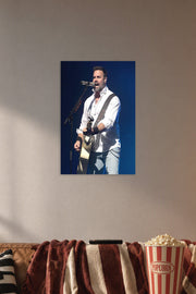 Male Singer Performing in a cozy movie room above a brown sofa with popcorn.