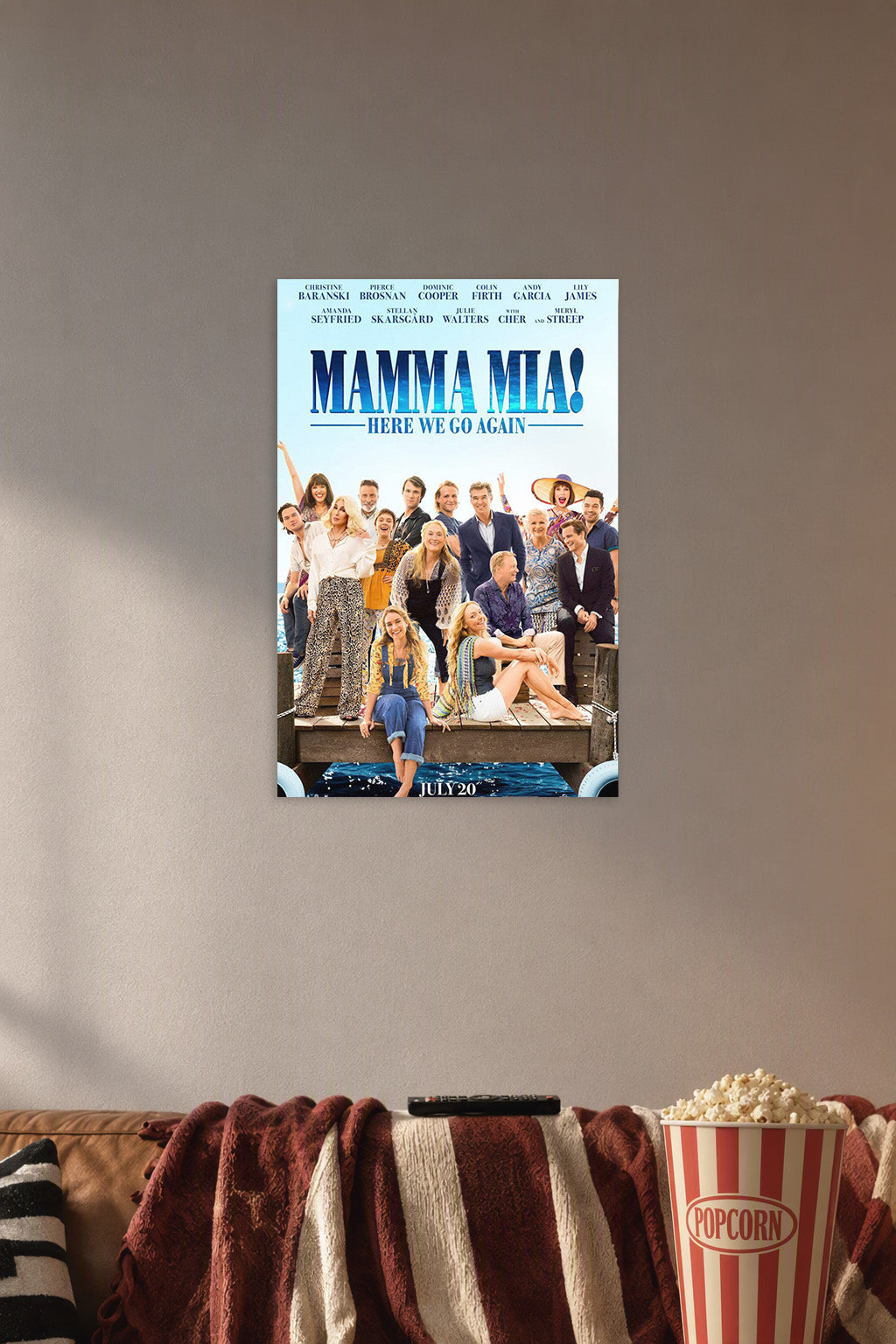 Mamma Mia! Here We Go Again Movie Cast in a cozy movie room above a brown sofa with popcorn.