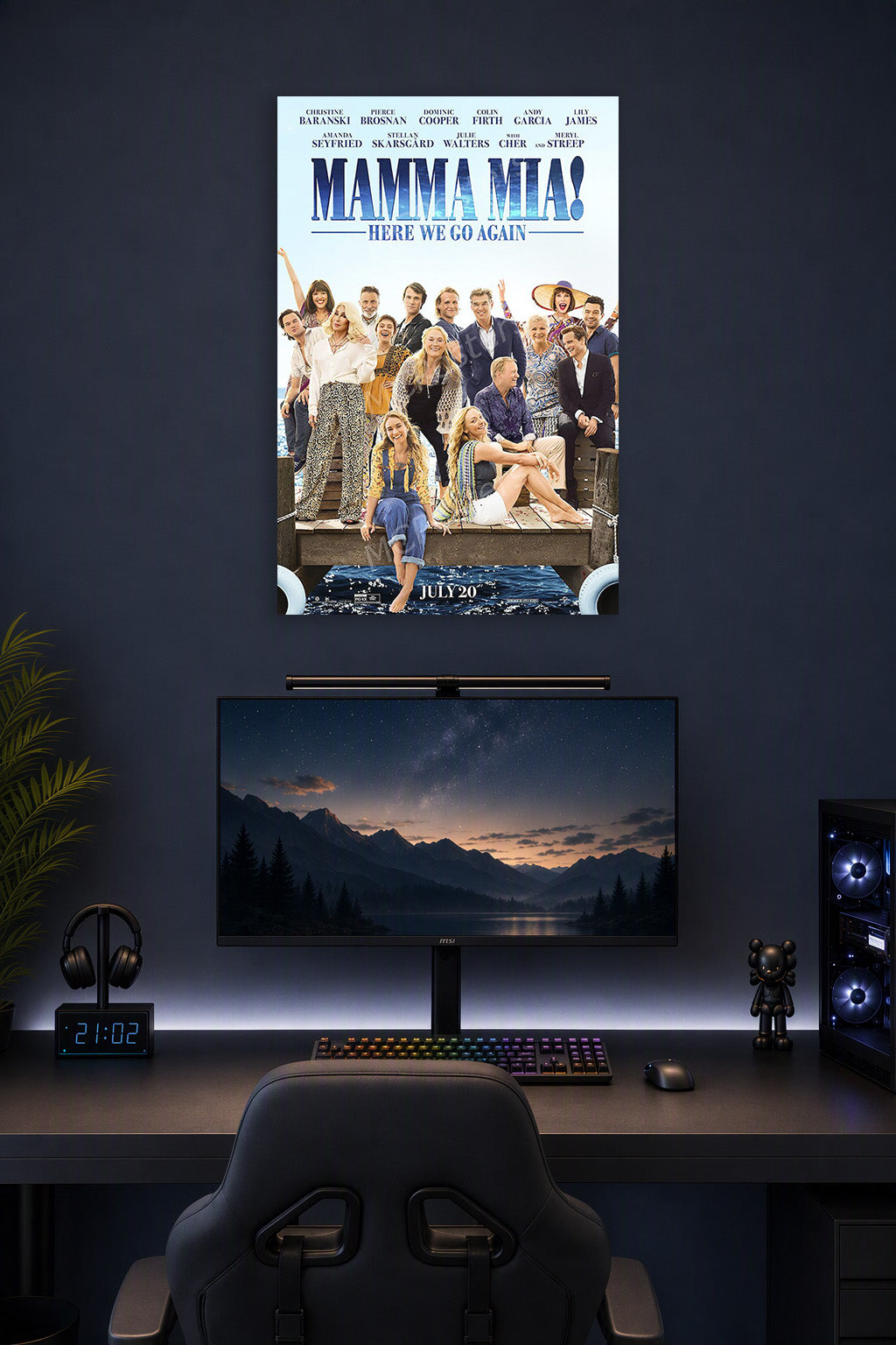 Mamma Mia! Here We Go Again Movie Poster in a gaming desk setup above a monitor.
