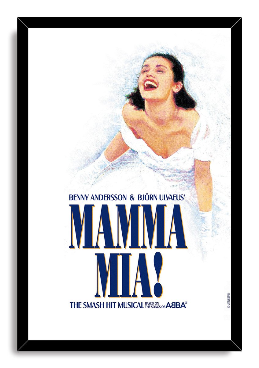 Mamma Mia! framed wall art print presents a laughing bride in a white gown, large navy and gold title text, and a black frame.