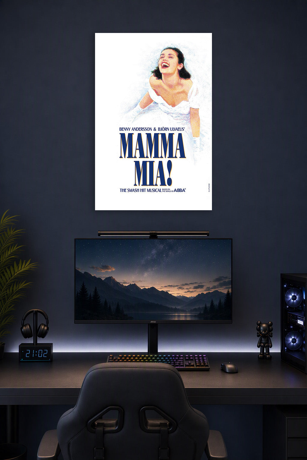 Mamma Mia! Musical in a gaming desk setup above a monitor.